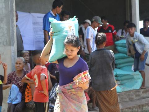 Affected people receiving relief food items and drinking water
