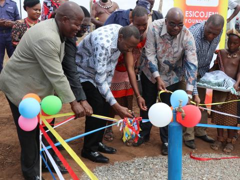 The Minister Peter Bhembe cutting the ribbon marking the official opening of the water scheme