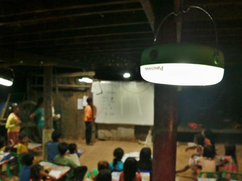 Panasonic lantern provides light for students to do their homework, Cambodia
