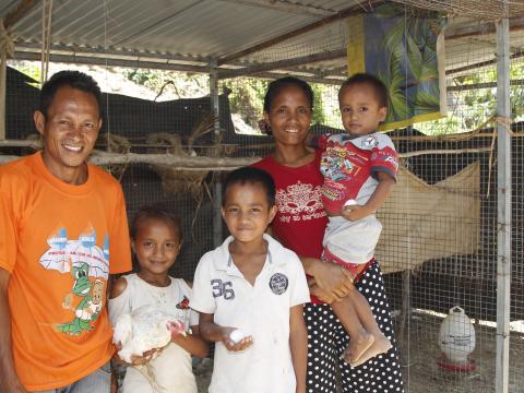 Alarico and Alzira with their children, Fersilia (aged eight), Bruno (aged 13) and Antonio (aged four) in front of their chicken coop. Photo: Jaime dos Reis/World Vision