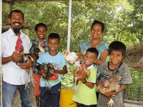 Tito, his wife Zulmira, and their four children (left to right) Sandra, 15, Ronaldo, 12, Floriano, 8 and Noberto, 10, with their flock of chickens. Photo: Jaime dos Reis/World Vision