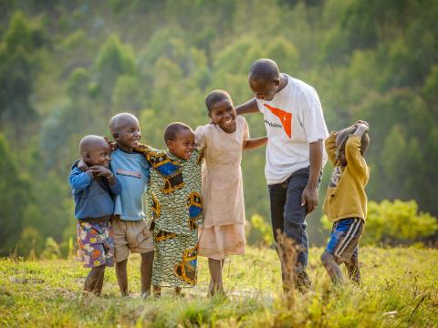 World Vision staff with 5 children