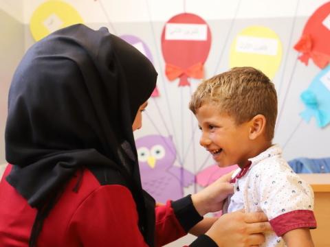 A refugee child in Syria is seen by a doctor