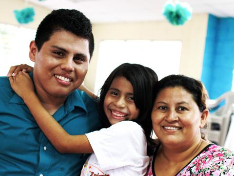 Elisa Gamero and Miguel Artiga with a child in El Salvador