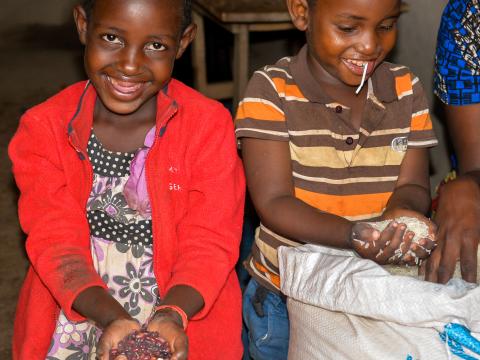 The Joy of having plenty of food in the house. Aline 10 and her brother Ndahanye 6 full of smiles knowing that today was distribution day and their mother came back home with a lot of food. 