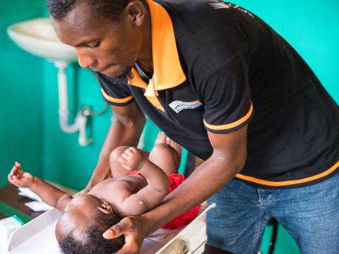 World Vision staff conducts check-ups of children at remote rural clinic