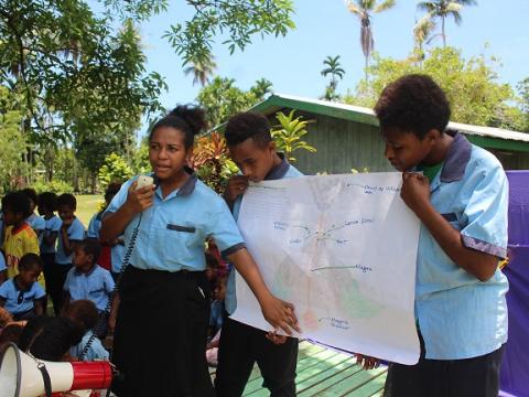 Lucy and her school mates from their DRR Club during in awareness on how a volcano may create a disaster.