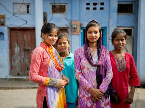 A group of Indian girls standing in an urban setting