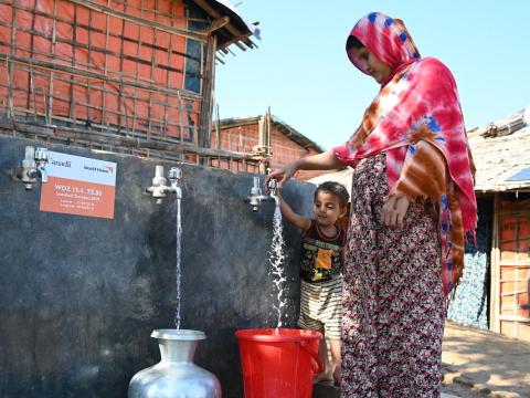 Shahanara, a Rohingya mother of three children, collects water from one of 30 water points in Camp 15 that provide chlorinated potable water to more than1,000 refugee and host community families. World Vision installed the innovative solar-powered water network, funded by Global Affairs Canada. Photo: Himaloy Joseph Mree, World Vision