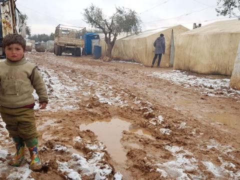 Syrian refugee in snow covered camp