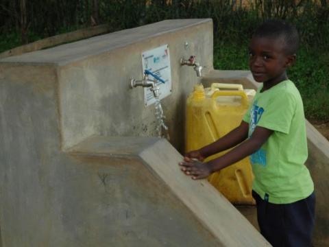 Chris fetching water from a safe & convenient water source.   