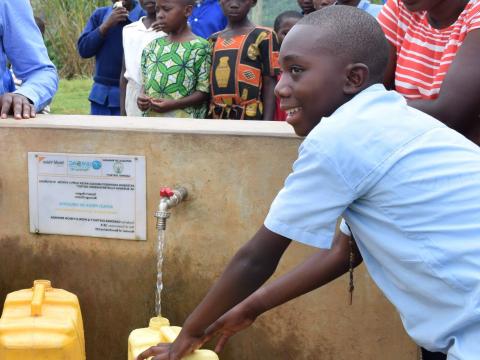 Lambert fetching clean water constructed close to his home