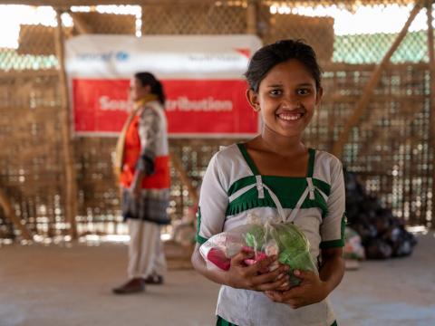 Nurankis, 11, happily receives soap for her family from World Vision.