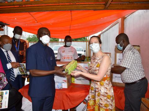 WV DRC National Director, Anne-Marie Connor, hands over an assortment of medical supplies to government to fight COVID19