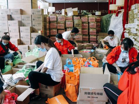 World Vision staff and partners packing relief packages for children and families during COVID-19