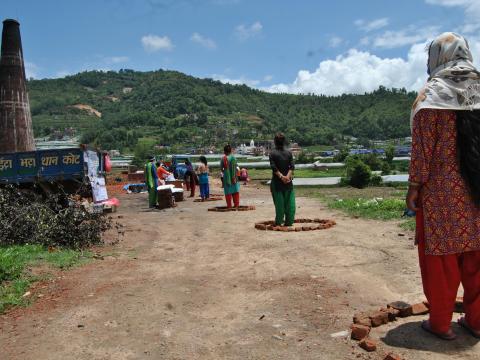 Beneficiaries stand in queue 