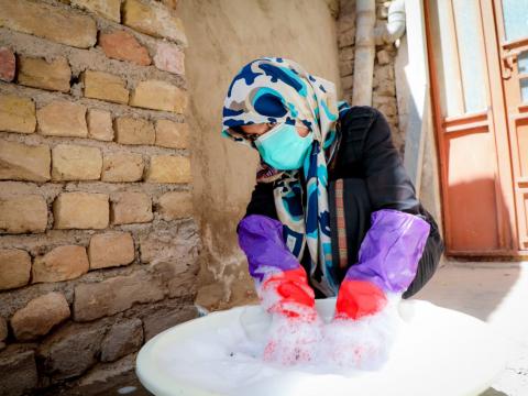 Sakina is in her work, washing clothes