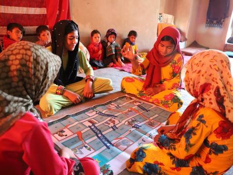 Girls are happy for playing chutes-and-ladders