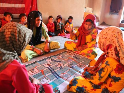 Girls are happy for playing chutes-and-ladders 