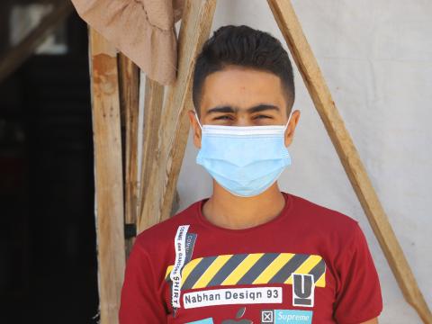 Ahmad in front of his tent in Bekaa