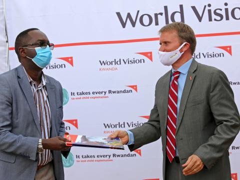 Sean Kerrigan,World Vision Rwanda National Director,presenting handover documents to Rwanda's Minister of Health, Dr. Daniel Ngamije 