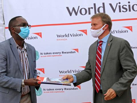 Sean Kerrigan,World Vision Rwanda National Director presenting handover documents to Dr. Daniel Ngamije,Rwanda's Minister of Health