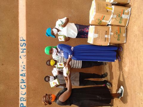 Stella Aber, Rakai Project Officer Resilience &Livelihoods giving out seeds to farmers