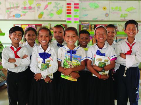 children standing in school with books