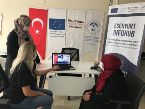 Refugees watching informative videos at IBC's info hub