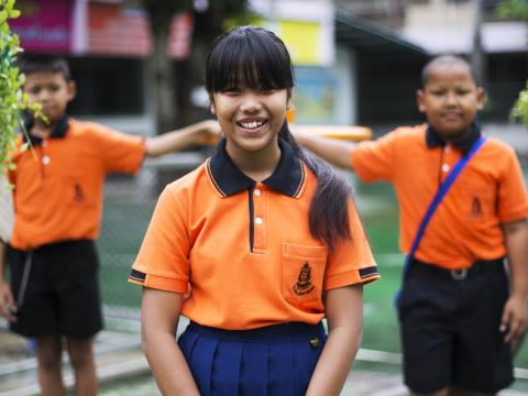 Girl from Thailand in orange shirt