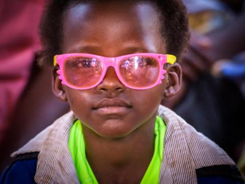 Child in pink glasses