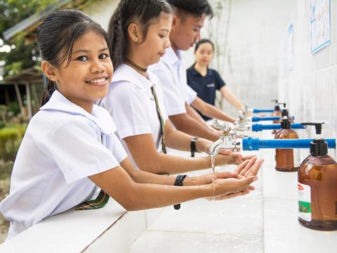 Children wash their hands at school, making education more accessible and enjoyable