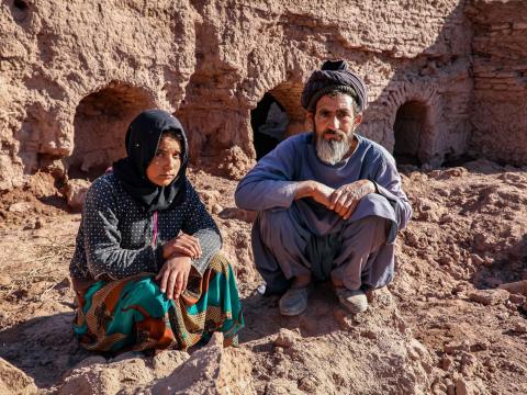 Vali and his daughter new to their ruined house by flood.