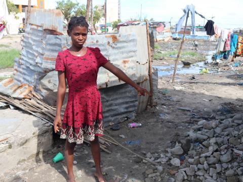 Elsa is pointing out the wreckage of her house after cyclone Eloise make a landfall