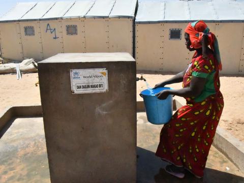 Amina fetches water at the pump