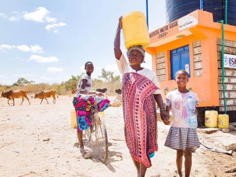 World Vision enhances access to clean water.Dama and her children Sidi and Saumu fetch water for their use in Mapotea, Kilifi County Kenya