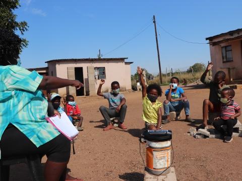 Eswatini children attending a radio broadcast class led by their teacher, as they practice social distancing, protecting themselves from COVID-19. World Vision Eswatini donated solar powered radios when schools closed due to the pandemic