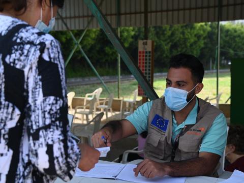 staff handing a paper