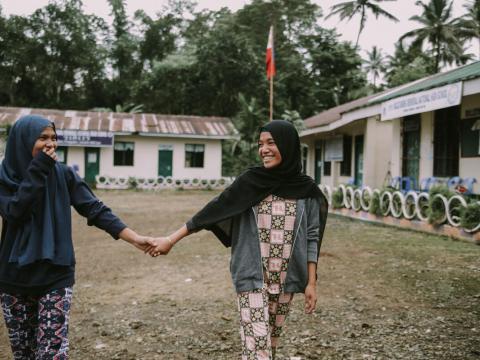 Young peacemaker girls in the Phippines hold hands