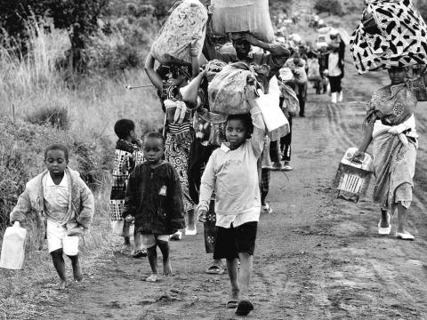 Refugee children walking with their belongings