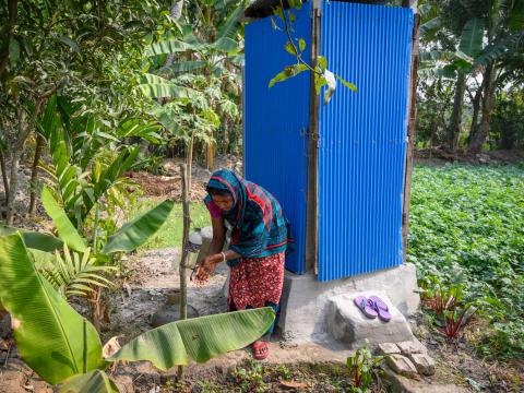 Woman uses new latrine for better health in Bangladesh