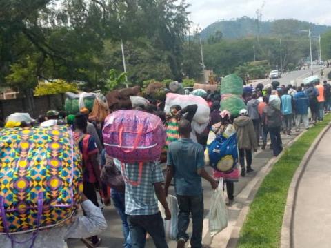Refugees walking along road leaving DRC