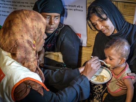Women feeding a child