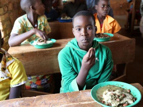 Child eating food at school feeding programme