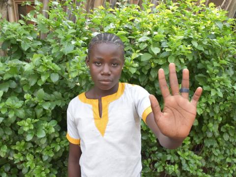 Girl holds her hand out against child marriage