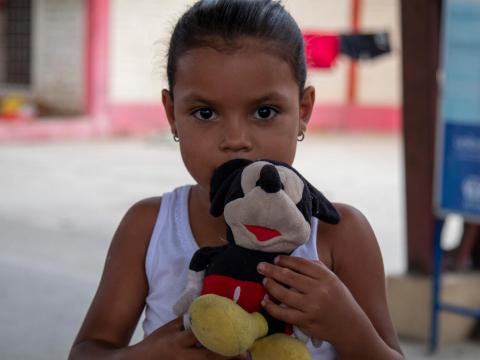 Ami and her Mickey Mouse toy fled Venezuela to the Ecuadorian border with Peru.