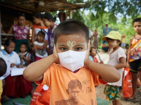 A child in Myanmar wearing a mask