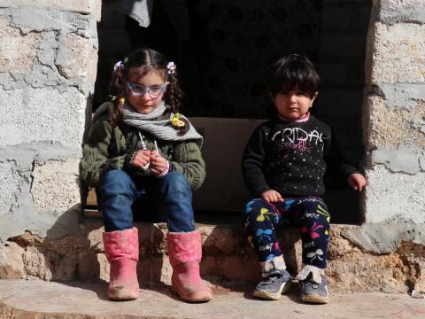 Syrian refugees sitting on a step