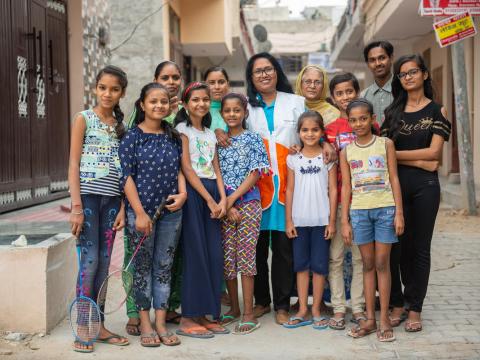 Anitha and the children she helps in her India community.
