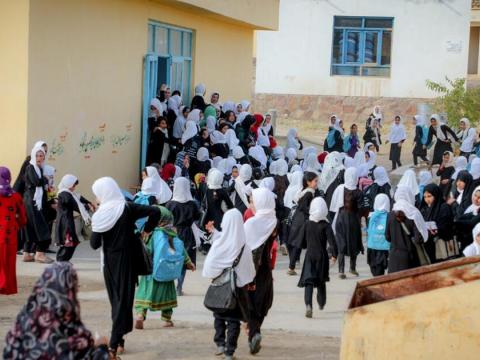 Girls walking through a village